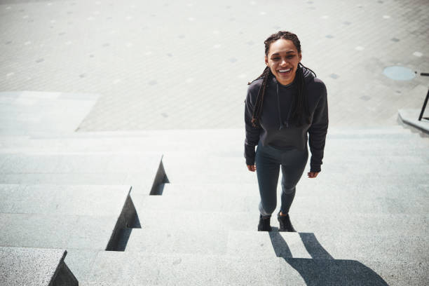 istock High-spirited woman with cornrows in activewear looking up 1329366079