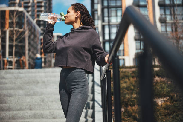istock Female athlete restoring her fluid balance after the workout 1329366167