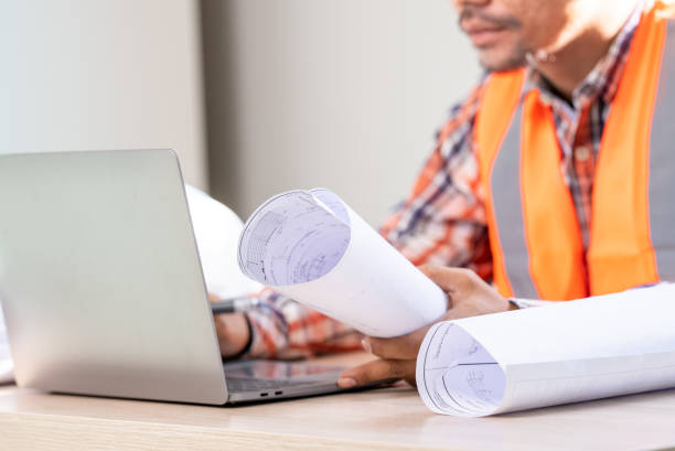 istock male engineer Working tools Engineer office desk with helmet at desk talbe 1329367220