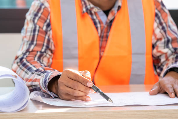 istock male engineer Working tools Engineer office desk with helmet at desk talbe 1329367225