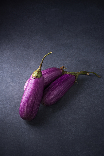 eggplant or brinjal, vegetables isolated on a dark background surface