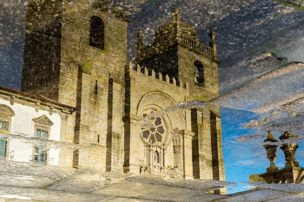 Reflexion of the catholic church in puddle in Porto, Portugal