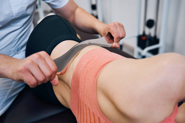 istock Male chiropractor is treating woman abdominal muscles 1329370676