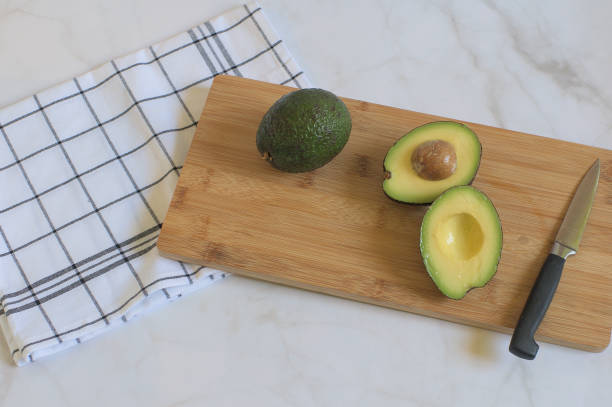 istock Fresh avocados on wooden board 1329371892