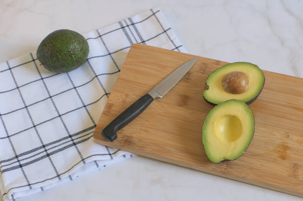 istock Fresh avocados on wooden board 1329371905