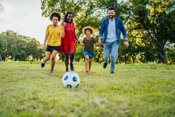 istock Mixed race family playing soccer 1329373602