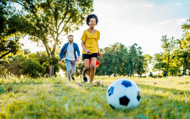 istock Family playing football 1329373707