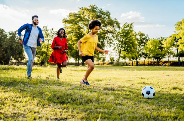 istock Playing soccer at the park 1329373790