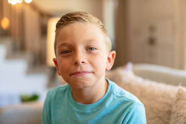 istock Young Boy Looking at Camera Smiling for a Portrait Photo Series 1329373867