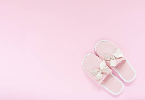 istock Pink home slippers on a pastel pink background. Top view. Copy space 1329373886