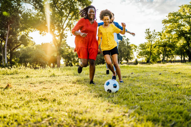 istock Mixed race family playing soccer 1329374524
