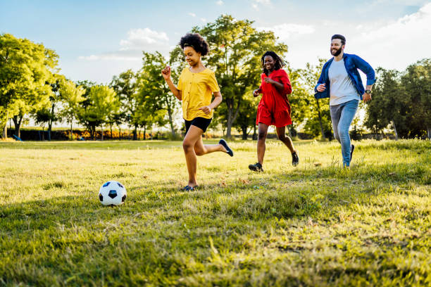 istock Playing soccer at the park 1329374559