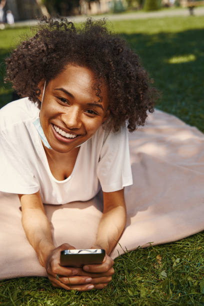 istock Contented young woman having pleasant time in the park 1329374622