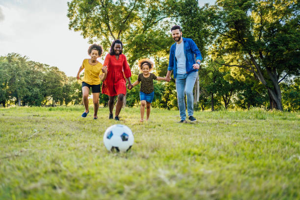 istock Mixed race family playing soccer 1329374631