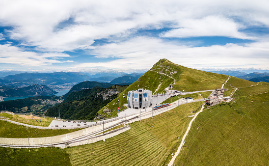 Monte Generoso, Switzerland - July 17. 2021: The popular excursion destination on the 1700 m. high monte Generoso with a modern restaurant and diverse hiking trails, Lugano lake areal at the background, Canton Ticino, Switzerland