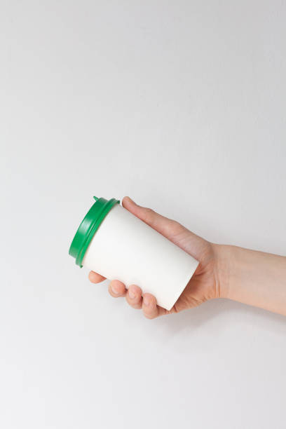istock Take away coffee cup background. Male hand holding a coffee paper cup 1329378882