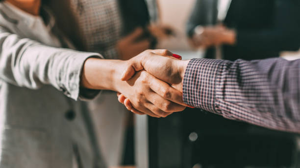 close up. young casual business people shaking hands with each stock photo