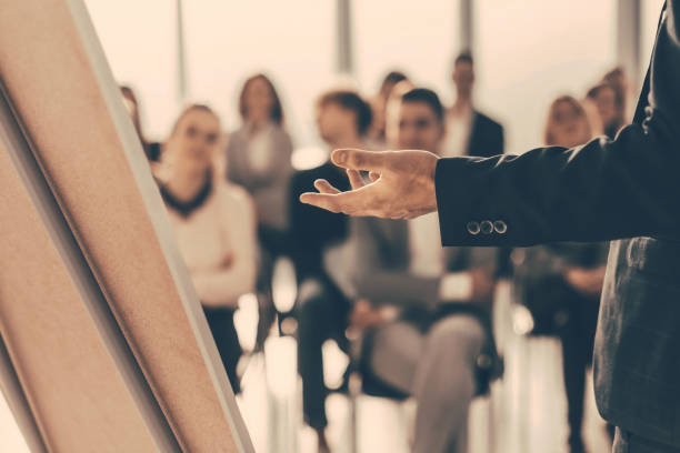istock close up. the speaker makes a report for the business team 1329380588