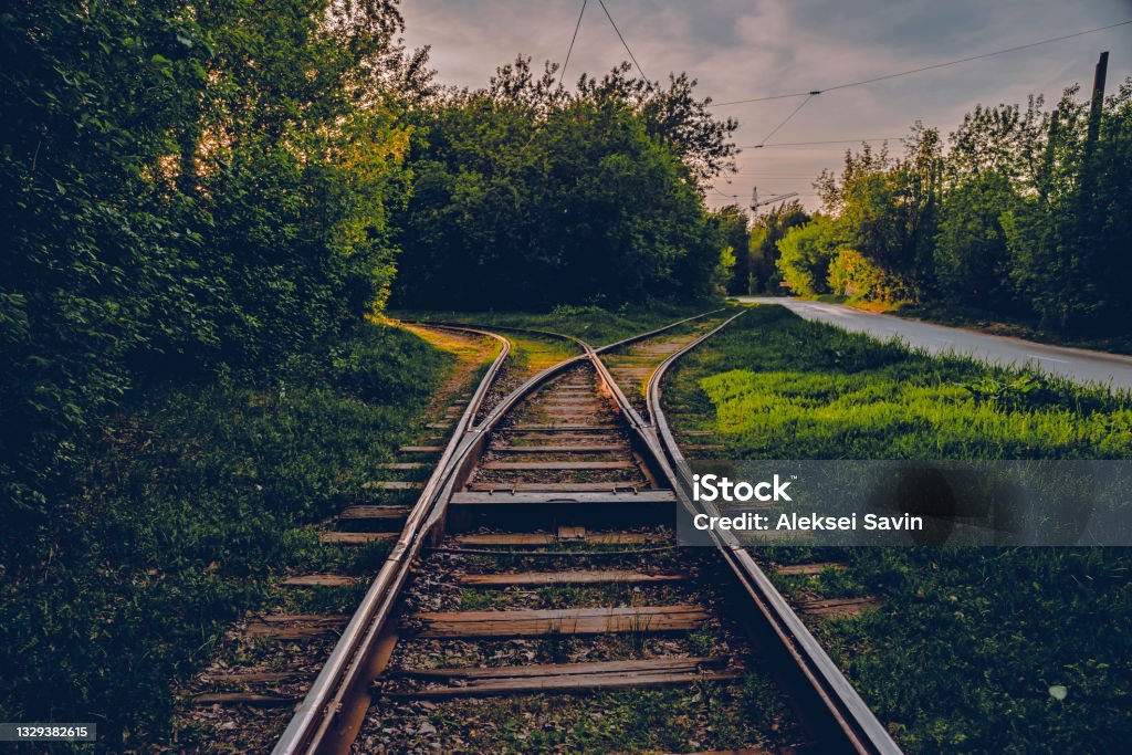 A fork in the railroad tracks in two directions. A close-up view of a railroad track A fork in the railroad tracks in two directions. A close-up view of a railroad track. Concept of industrial logistic and transportation background Rail Transportation Stock Photo