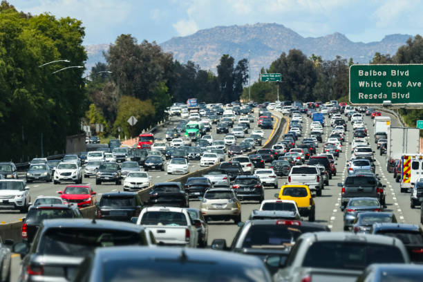 Traffic Jam Traffic and street signs on an LA freeway. traffic jam stock pictures, royalty-free photos & images