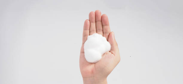 istock Hand washing gesture with foaming hand soap and bubble on white background. 1329387358