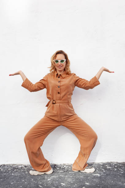 A young woman in a strange funny pose on a white background