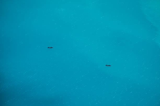 Distance view of two canoers on Lake Louise, Banff National Park.