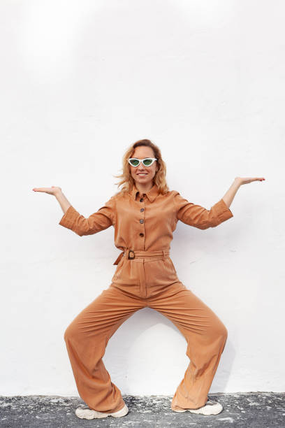 istock A young woman in a strange funny pose on a white background 1329390066