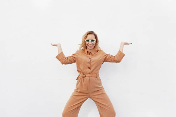 istock A young woman in a strange funny pose on a white background 1329390970