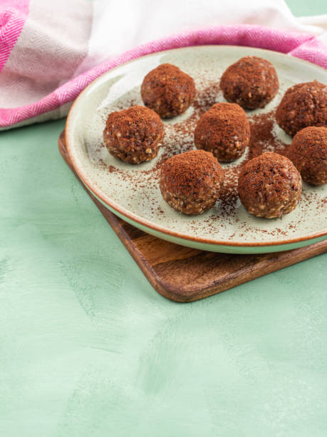 istock Chocolate cocoa energy balls with nut butter on green dish 1329391421