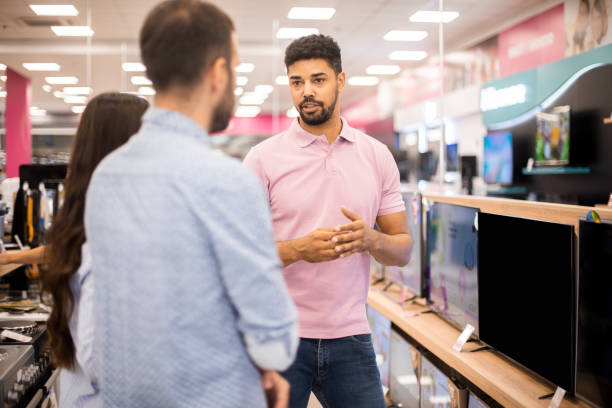 istock Young salesman assisting to customers 1329392339
