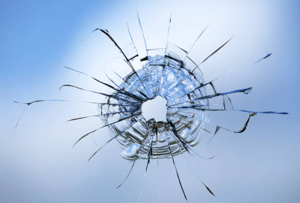 istock Cracks in the window glass on a background of sky. 1329393116