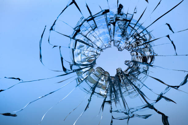 istock Cracks in the window glass on a background of sky. 1329393124