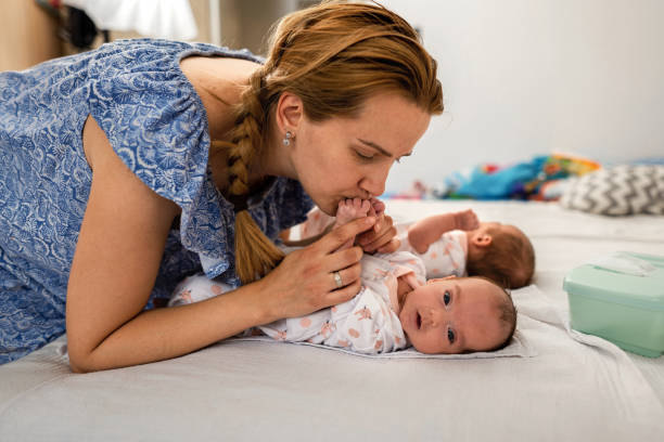 istock Mother with her twins baby 1329393475