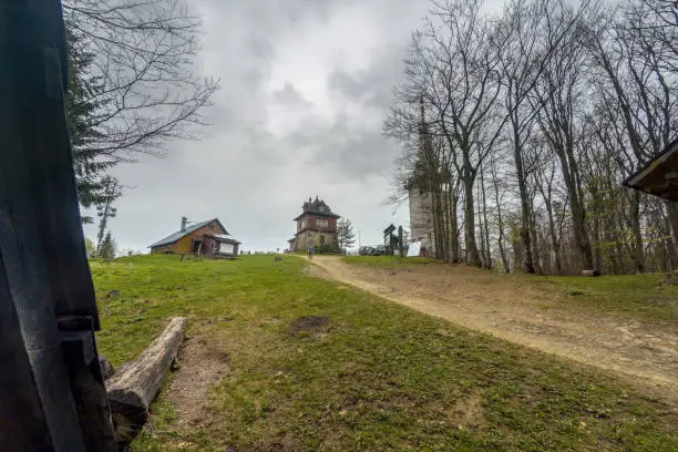 Pathway to a viewpoint at a peak of Polish mountain called Lubon Wielki located in a region of Beskid Wyspowy famous for hike amongst tourists. A radio and tv broadcasting center on the left.