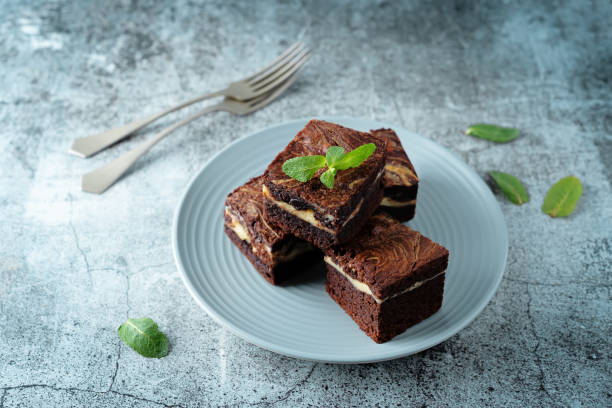 istock Cream cheese chocolate brownie with mint leaves 1329394426
