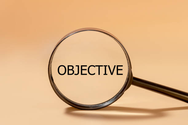istock Business objective target and goal concept, Black Objective wording on magnifier glass. 1329395757