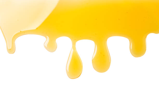 istock Honey drops are flowing on a white background. Top view. 1329395832