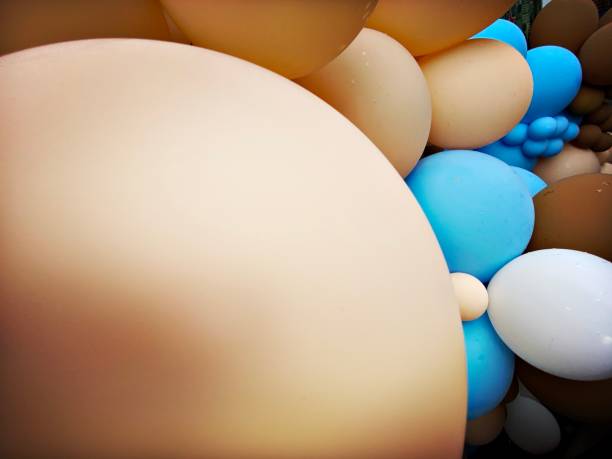 istock Brown and Blue Balloons against a Brick Wall 1329396612