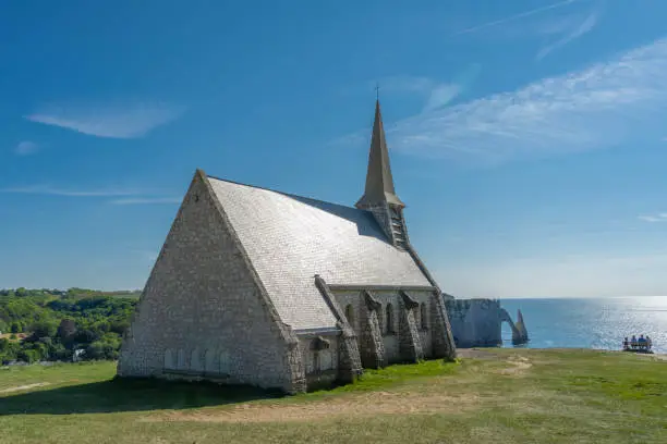 Etretat, France - 05 31 2019: Fishermen's Chapel on the top of the cliffs of Etretat at sunset