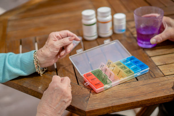 istock Close up of senior couple's hand while taking their medicaments 1329399214