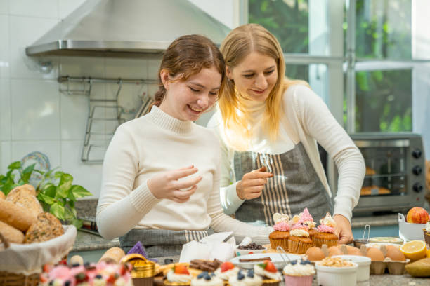 istock Mother and daughter are happily working together in baking. 1329403991