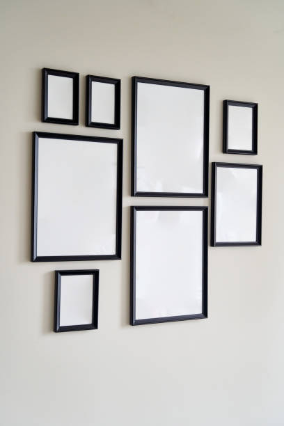 istock Different size framed photos hanging on the gray wall. Mockup 1329405105