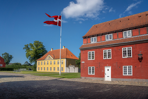 Kastellet fortress buildings and the Commander House with the flag of Denmark - Copenhagen, Denmark