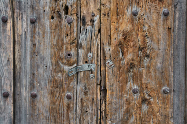 Antique wooden door with rusted hardware