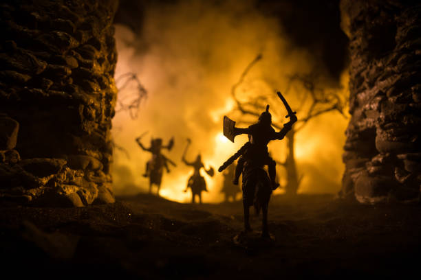 istock Medieval battle scene with cavalry and infantry. Silhouettes of figures as separate objects, fight between warriors on dark toned foggy background with medieval castle. 1329408926
