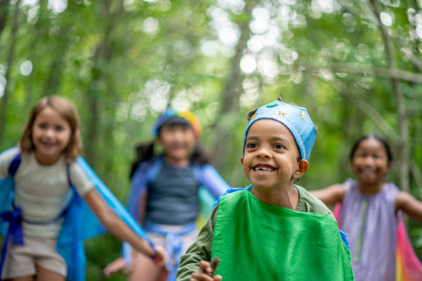 istock Kids playing in the forest with colorful silks 1329409699
