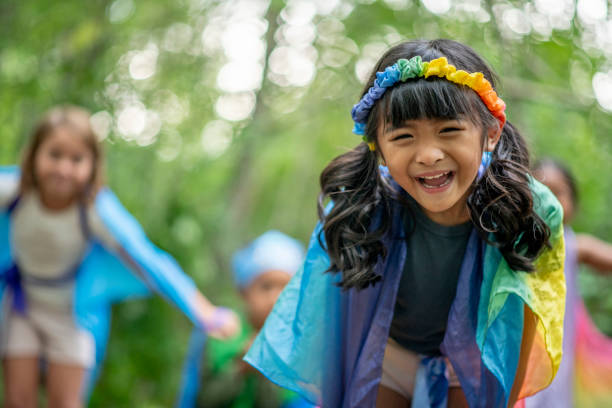 istock Kids playing in the forest with colorful silks 1329409706