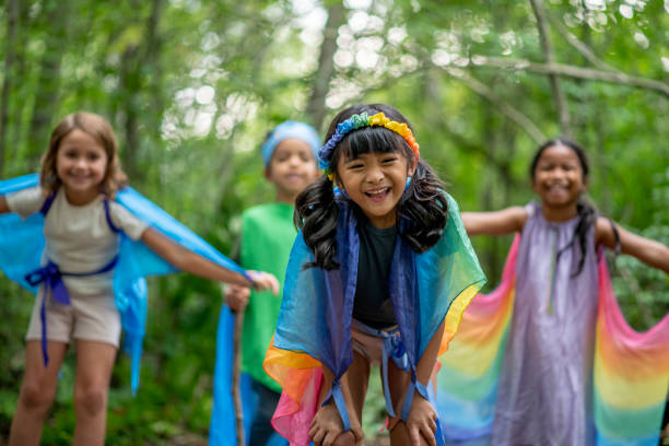 Kids playing in the forest with colorful silks