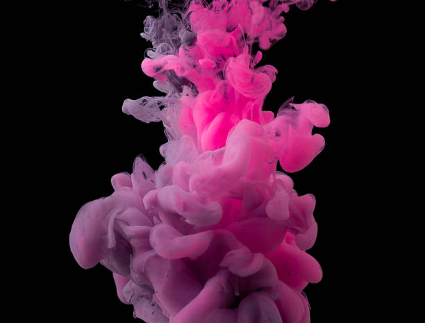 istock multi colored acrylic paints are mixed in clubs and dissolves in water. Black background. 1329409760